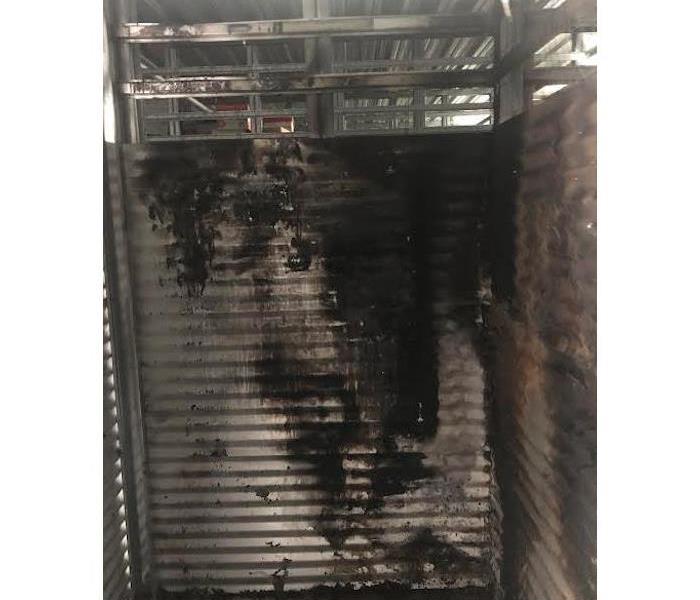 Metal stall with fire damage.
