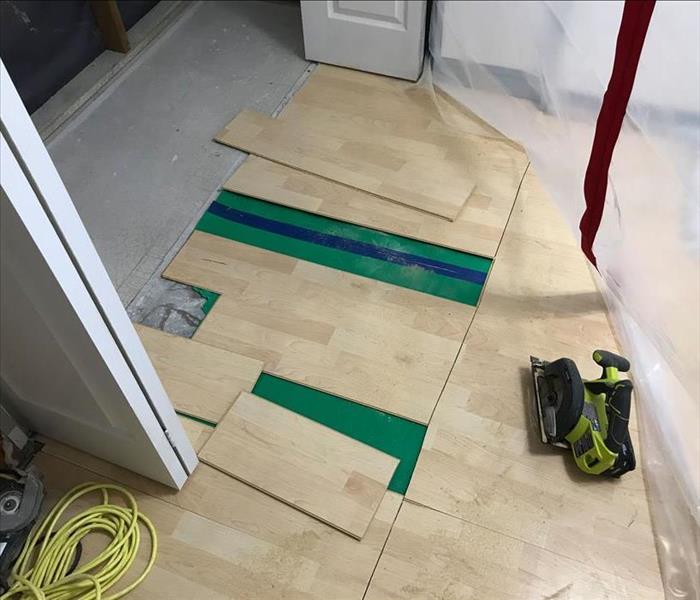 Vinyl plank flooring being removed.